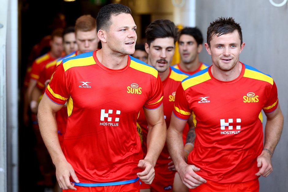 AFL 2017 JLT Community Series - Gold Coast Suns v Western Bulldogs GOLD COAST, AUSTRALIA - MARCH 09: Steven May and Pearce Hanley of the Suns run out for warm up before the JLTR Community Series AFL match between the Gold Coast Suns and the Western Bulldogs at Metricon Stadium on March 9, 2017 in Gold Coast, Australia. (Photo by Chris Hyde/Getty Images)